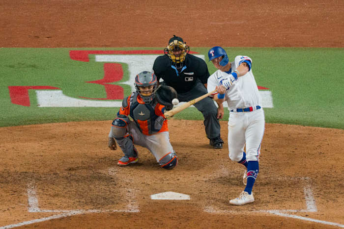 Oct 18, 2023; Arlington, Texas, USA; Texas Rangers third baseman Josh Jung (6) hits a two run home run against the Houston Astros during the seventh inning during game three of the ALCS for the 2023 MLB playoffs at Globe Life Field. Mandatory Credit: Jerome Miron-USA TODAY Sports